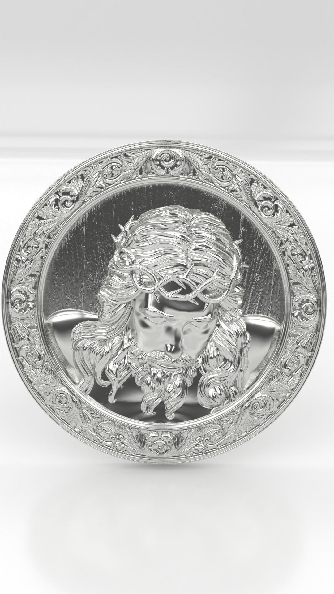 Pinjente redondo com o rosto de Jesus cruscificado, em prata 925.
